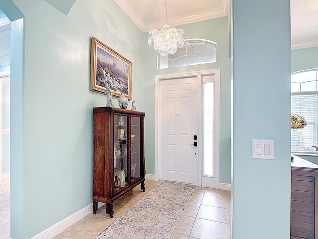 780 SW Fortunella Cir SW, Vero Beach, FL 32968 - entrance foyer with ornamental molding, light tile patterned floors, and a chandelier