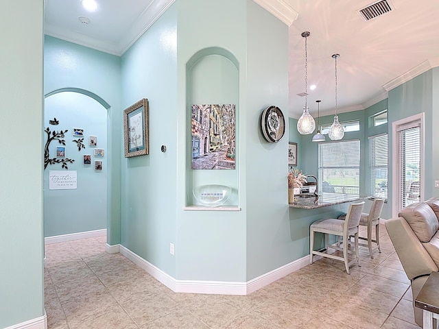 780 SW Fortunella Cir SW, Vero Beach, FL 32968 - hallway with crown molding, tile patterned floors, and arched walkways