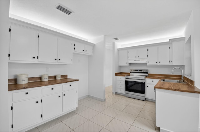 5791 Spindle Palm Ct Unit D, Delray Beach, FL 33484 - kitchen featuring stainless steel electric stove, under cabinet range hood, white cabinets, light tile patterned flooring, and butcher block counters