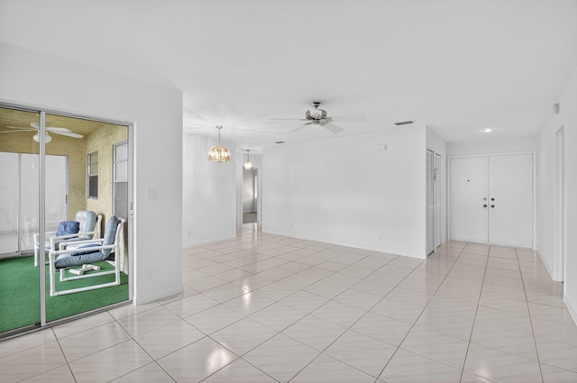 5791 Spindle Palm Ct Unit D, Delray Beach, FL 33484 - empty room featuring ceiling fan, a chandelier, and light tile patterned flooring