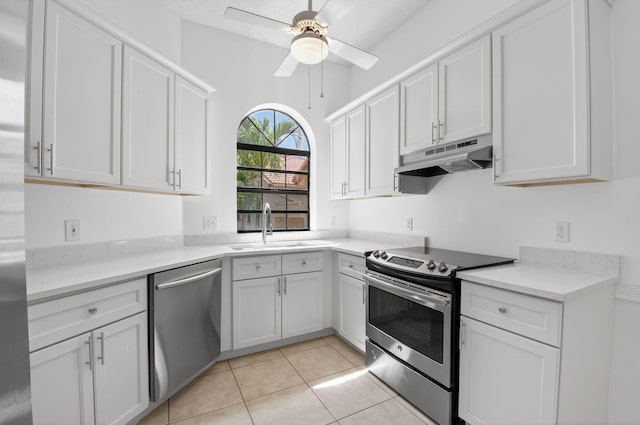 5235 Europa Dr Unit K, Boynton Beach, FL 33437 - kitchen featuring appliances with stainless steel finishes, under cabinet range hood, ceiling fan, white cabinets, and light countertops