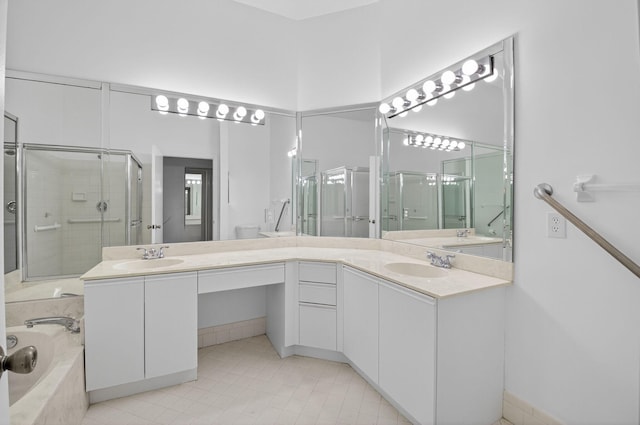 5235 Europa Dr Unit K, Boynton Beach, FL 33437 - bathroom featuring a stall shower, double vanity, a bath, and tile patterned floors