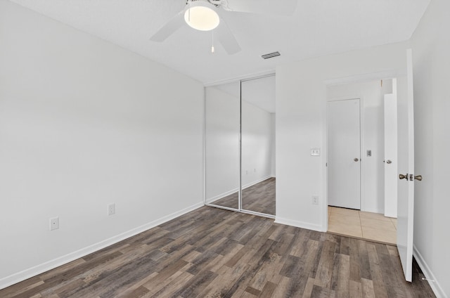 5235 Europa Dr Unit K, Boynton Beach, FL 33437 - unfurnished bedroom with wood finished floors, a closet, and a ceiling fan