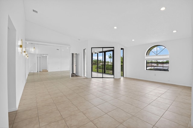 5235 Europa Dr Unit K, Boynton Beach, FL 33437 - empty room featuring vaulted ceiling, plenty of natural light, recessed lighting, and light tile patterned floors
