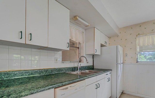 4840 Pineaire Ln, West Palm Beach, FL 33417 - kitchen featuring white appliances, dark countertops, white cabinetry, a wainscoted wall, and tasteful backsplash