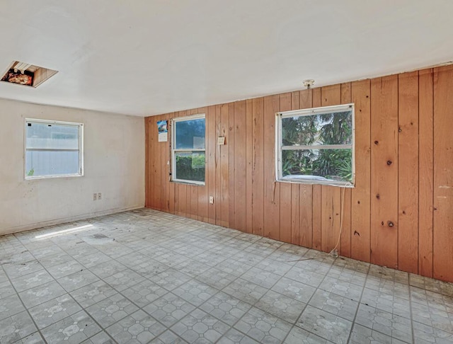 4840 Pineaire Ln, West Palm Beach, FL 33417 - unfurnished room with wood walls and tile patterned floors