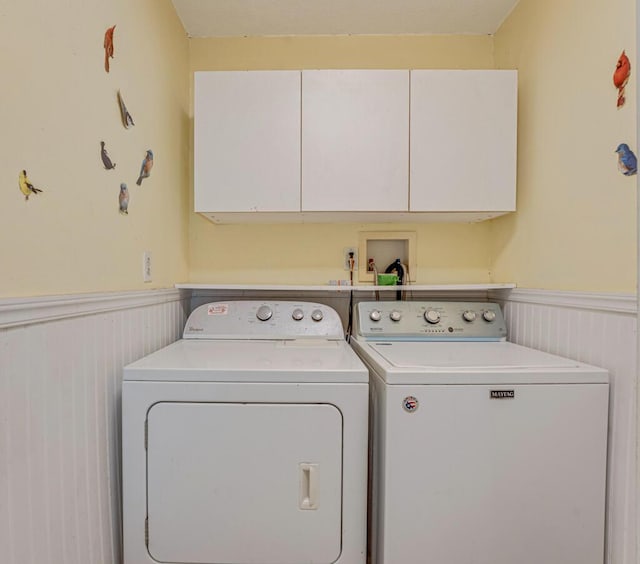 4840 Pineaire Ln, West Palm Beach, FL 33417 - laundry room featuring cabinet space, a wainscoted wall, and washer and clothes dryer