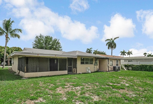 4840 Pineaire Ln, West Palm Beach, FL 33417 - back of house featuring a sunroom and a yard