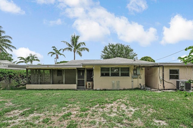 4840 Pineaire Ln, West Palm Beach, FL 33417 - rear view of house with a sunroom and a lawn