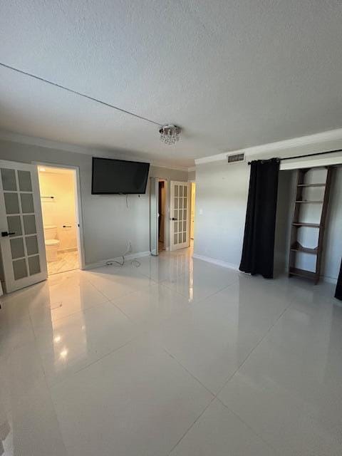 808 SE 7th St Unit 107, Deerfield Beach, FL 33441 - unfurnished room with a textured ceiling and light tile patterned floors