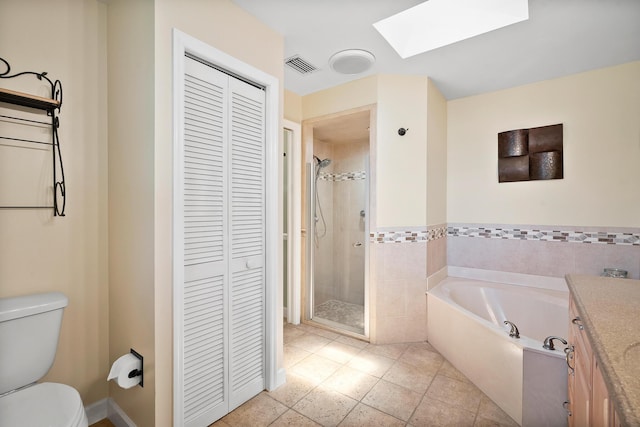 3003 SW Seaboard Ave, Palm City, FL 34990 - bathroom featuring a closet, a skylight, a shower stall, a bath, and tile patterned flooring
