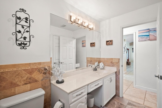 3003 SW Seaboard Ave, Palm City, FL 34990 - bathroom with tile walls, vanity, tile patterned floors, and a wainscoted wall