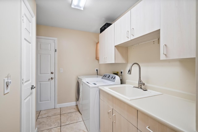 3003 SW Seaboard Ave, Palm City, FL 34990 - laundry area featuring cabinet space, washing machine and dryer, and light tile patterned floors