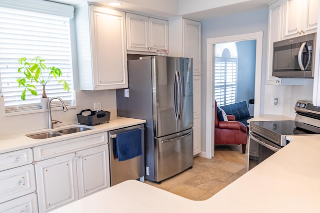 11355 SW Rockingham Dr, Port Saint Lucie, FL 34987 - kitchen with appliances with stainless steel finishes, white cabinets, and light countertops