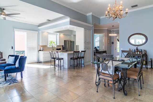 11355 SW Rockingham Dr, Port Saint Lucie, FL 34987 - dining space featuring crown molding, ceiling fan, and a chandelier