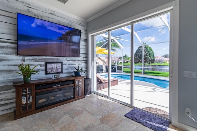 11355 SW Rockingham Dr, Port Saint Lucie, FL 34987 - doorway with ornamental molding, a sunroom, and stone finish flooring