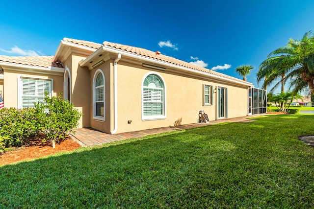 11355 SW Rockingham Dr, Port Saint Lucie, FL 34987 - back of house with a lawn, a tile roof, and stucco siding