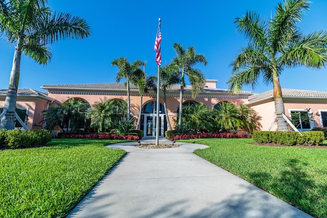 11355 SW Rockingham Dr, Port Saint Lucie, FL 34987 - view of front facade featuring a front lawn, stucco siding, and a tiled roof