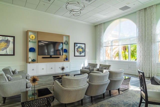 11355 SW Rockingham Dr, Port Saint Lucie, FL 34987 - living room with crown molding, wood finished floors, a decorative wall, and a wainscoted wall