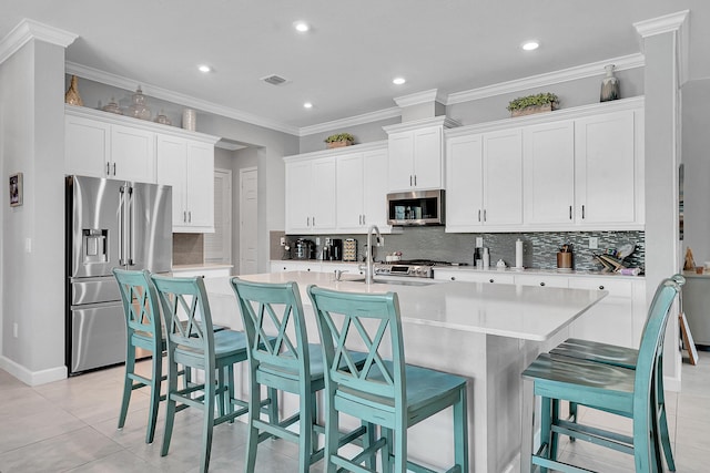 1120 Wandering Willow Way, Loxahatchee, FL 33470 - kitchen featuring stainless steel appliances, white cabinetry, backsplash, a kitchen island with sink, and recessed lighting