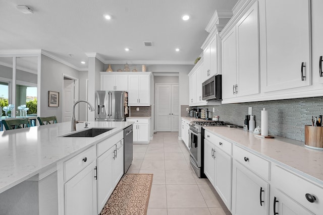 1120 Wandering Willow Way, Loxahatchee, FL 33470 - kitchen with appliances with stainless steel finishes, crown molding, backsplash, recessed lighting, and white cabinets