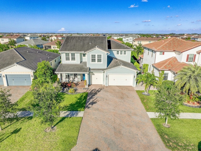 1120 Wandering Willow Way, Loxahatchee, FL 33470 - view of front facade with decorative driveway, a residential view, a porch, and a garage