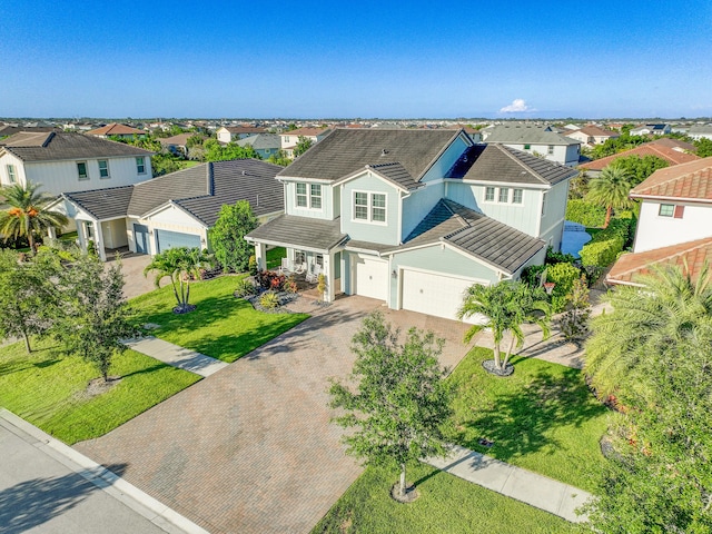 1120 Wandering Willow Way, Loxahatchee, FL 33470 - view of front of home with a residential view, decorative driveway, a front lawn, and a garage