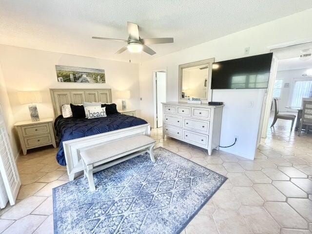 188 Upminster I Unit 188, Deerfield Beach, FL 33442 - bedroom with a textured ceiling and a ceiling fan