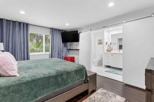 3469 Deer Creek Palladian Cir, Deerfield Beach, FL 33442 - bedroom featuring wood finished floors, recessed lighting, a barn door, and connected bathroom