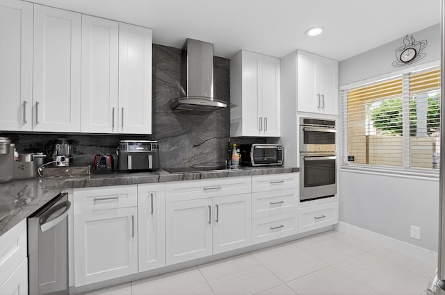 3469 Deer Creek Palladian Cir, Deerfield Beach, FL 33442 - kitchen with wall chimney range hood, stainless steel appliances, decorative backsplash, white cabinetry, and dark stone counters