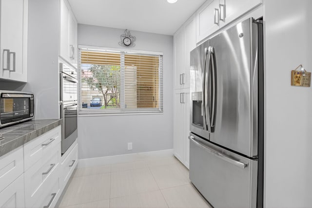 3469 Deer Creek Palladian Cir, Deerfield Beach, FL 33442 - kitchen featuring stainless steel appliances, white cabinets, light tile patterned floors, and tile countertops