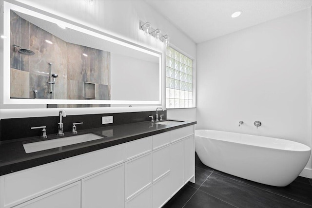 204 Clocktower Dr, Jupiter, FL 33458 - bathroom with a freestanding bath, walk in shower, double vanity, and tile patterned flooring