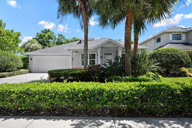 204 Clocktower Dr, Jupiter, FL 33458 - single story home with an attached garage, driveway, and stucco siding