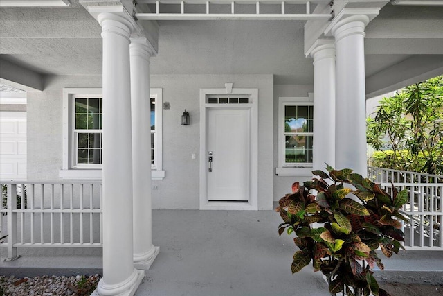 204 Clocktower Dr, Jupiter, FL 33458 - entrance to property featuring a porch and stucco siding