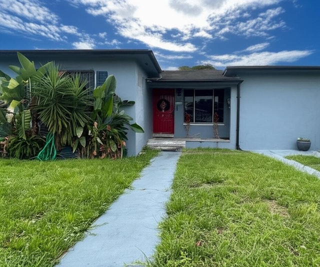 3332 NW 51st St, Miami, FL 33142 - view of front of house featuring stucco siding and a front lawn