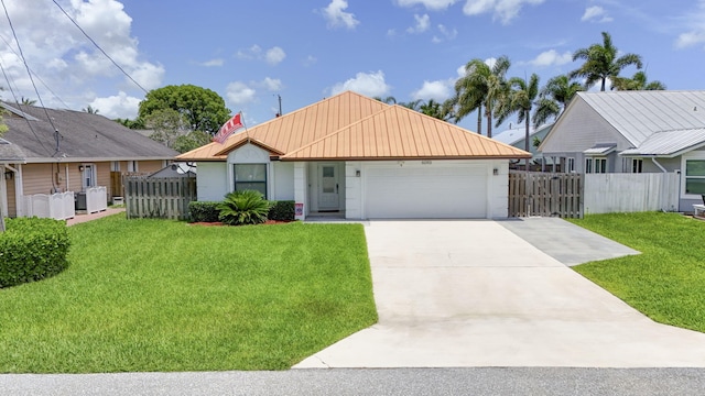 6093 Lucerne St, Jupiter, FL 33458 - view of front facade featuring a garage, a metal roof, driveway, and stucco siding