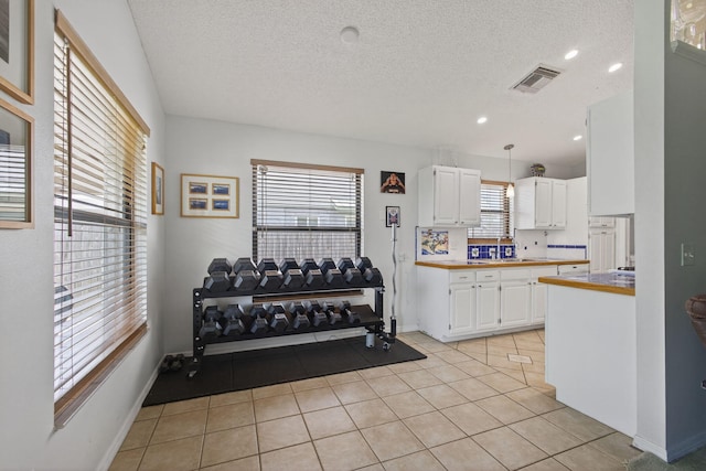 6093 Lucerne St, Jupiter, FL 33458 - exercise area with a textured ceiling, light tile patterned floors, and recessed lighting