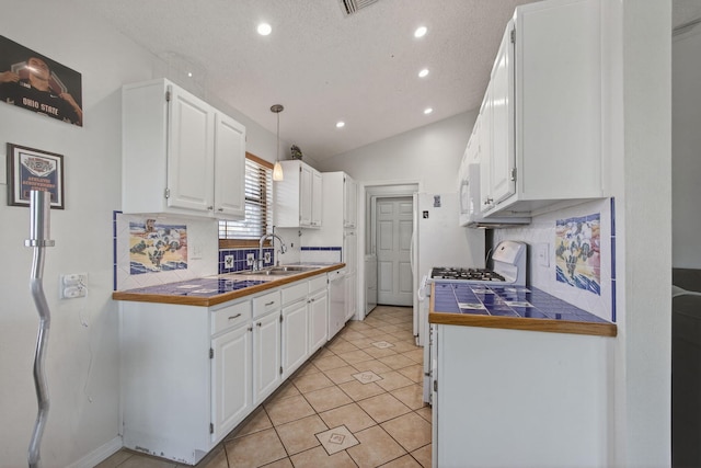 6093 Lucerne St, Jupiter, FL 33458 - kitchen with white cabinetry, recessed lighting, tasteful backsplash, white appliances, and light tile patterned floors