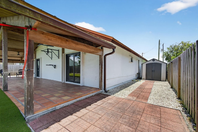 6093 Lucerne St, Jupiter, FL 33458 - fenced backyard featuring a storage unit and a patio