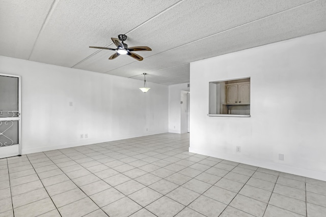300 Village Green Cir S Unit 120, Palm Springs, FL 33461 - empty room with a ceiling fan, a textured ceiling, and light tile patterned floors