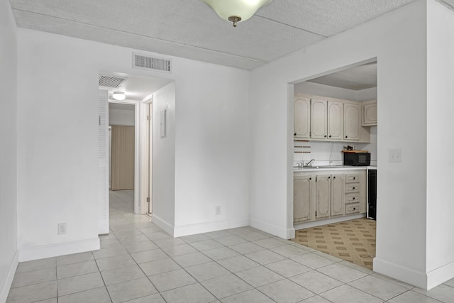 300 Village Green Cir S Unit 120, Palm Springs, FL 33461 - unfurnished room with light tile patterned floors and a textured ceiling