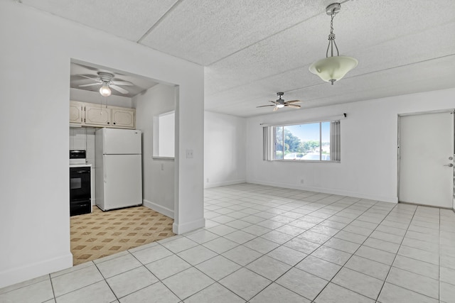 300 Village Green Cir S Unit 120, Palm Springs, FL 33461 - kitchen featuring freestanding refrigerator, a ceiling fan, stove, and light tile patterned flooring