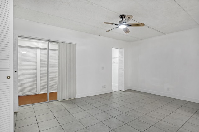 300 Village Green Cir S Unit 120, Palm Springs, FL 33461 - unfurnished bedroom with light tile patterned floors and a ceiling fan