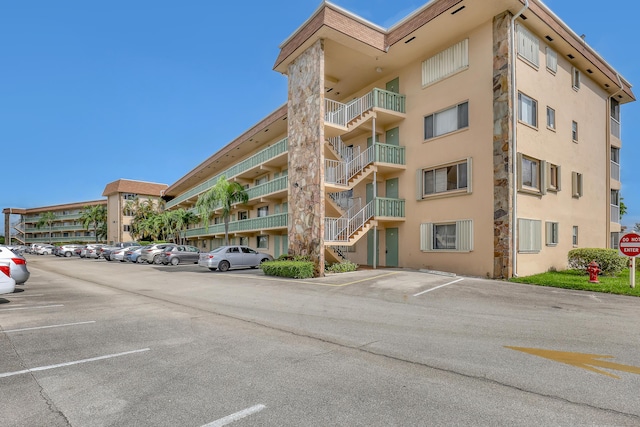 300 Village Green Cir S Unit 120, Palm Springs, FL 33461 - view of apartment building / complex featuring uncovered parking