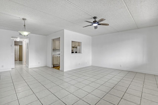 300 Village Green Cir S Unit 120, Palm Springs, FL 33461 - spare room with a ceiling fan, light tile patterned floors, and a textured ceiling