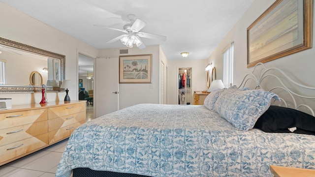 1630 NW 18th Ave Unit 101, Delray Beach, FL 33445 - bedroom featuring light tile patterned floors, ceiling fan, and a spacious closet