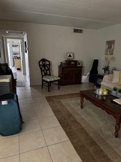3000 Springdale Blvd Unit V204, Palm Springs, FL 33461 - tiled living area featuring a textured ceiling