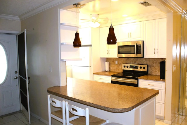 455 High Point Blvd Unit D, Delray Beach, FL 33445 - kitchen with stainless steel appliances, decorative backsplash, ornamental molding, light tile patterned flooring, and white cabinetry