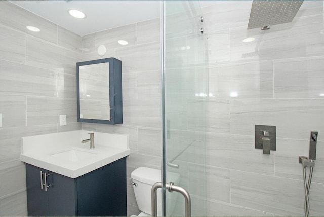 3580 Dunes Rd, Palm Beach Gardens, FL 33410 - bathroom featuring a stall shower, vanity, and tile walls