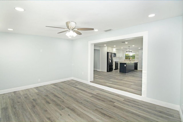 3580 Dunes Rd, Palm Beach Gardens, FL 33410 - unfurnished living room featuring recessed lighting, a ceiling fan, and wood finished floors